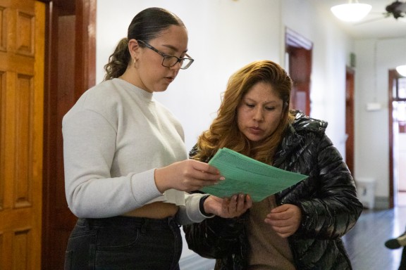 Two Latine people looking over a tax form