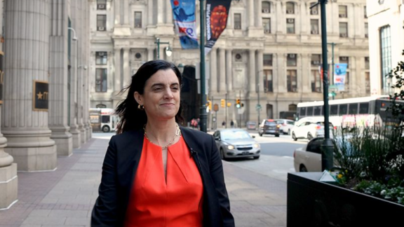 Rebecca Rhynhart walking down a street near Philadelphia City Hall