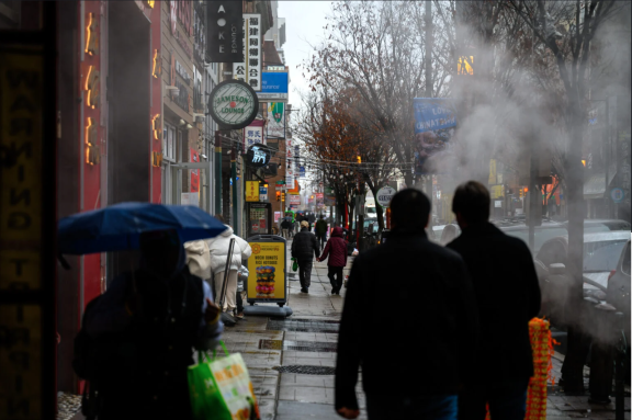 Philadelphia residents walking down a street in Chinatown 