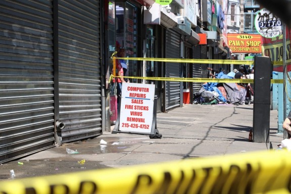 Streetscape with closed storefronts and police caution tape