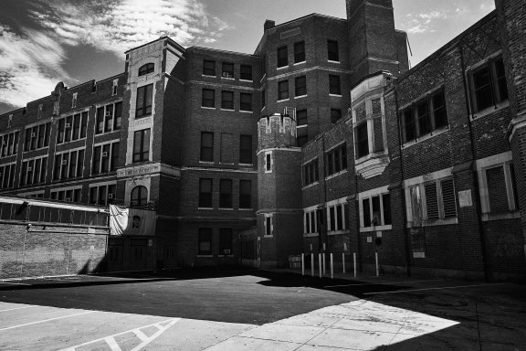 Black and white photo of a large, brick high school