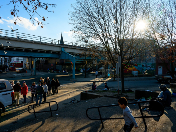 People hanging out in a community space near public transportation