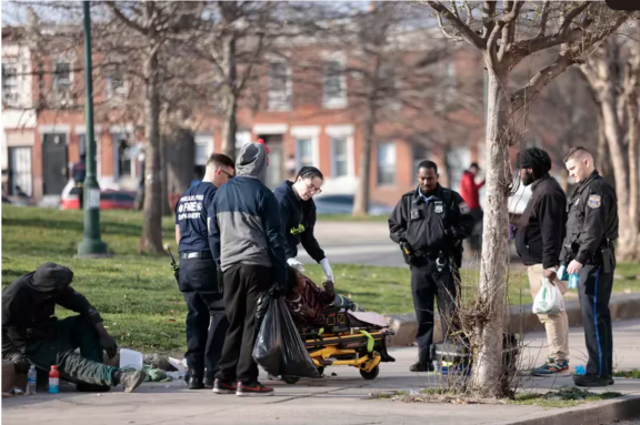 First responders adminstering Narcan to a potential overdose victim