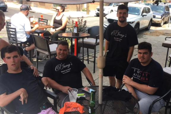 Louis Jung and three sons around an outdoor restaurant table