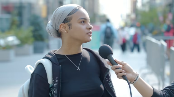 A woman being interviewed on the street