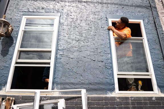 Contractor installing a window 