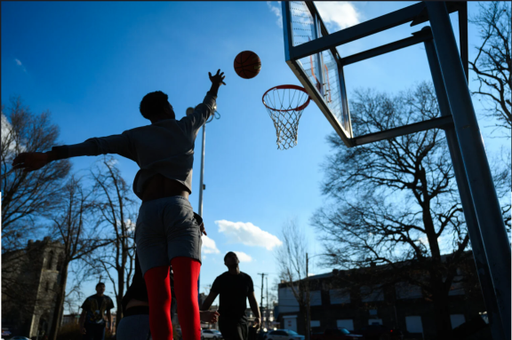 A young person playing basketball in Philadelphia