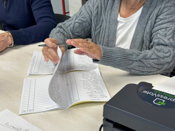 A Philadelphia poll worker keeps a manual record of voters as a backup to the county's electronic poll books