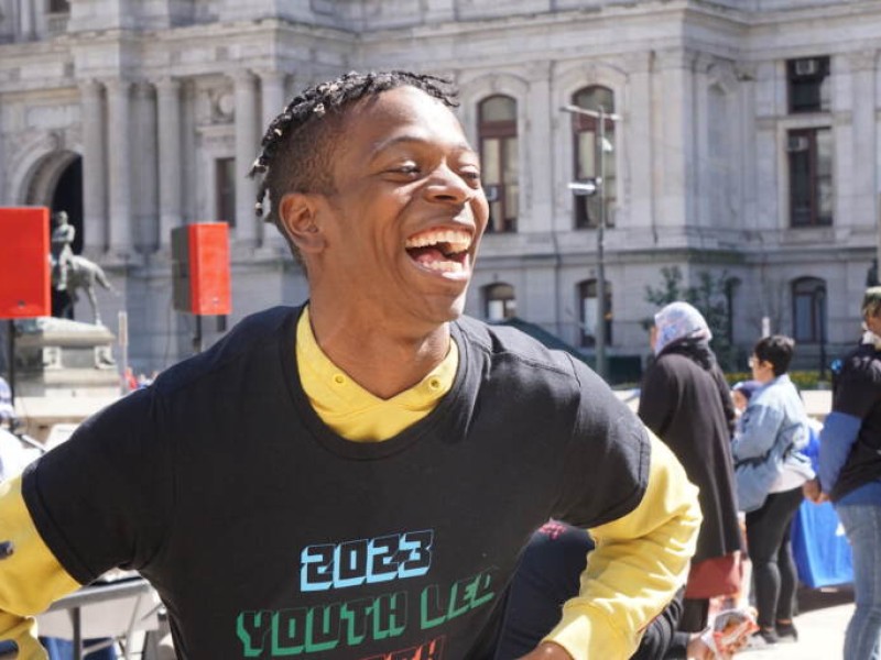 Activist in front of City Hall during rally against gun violence