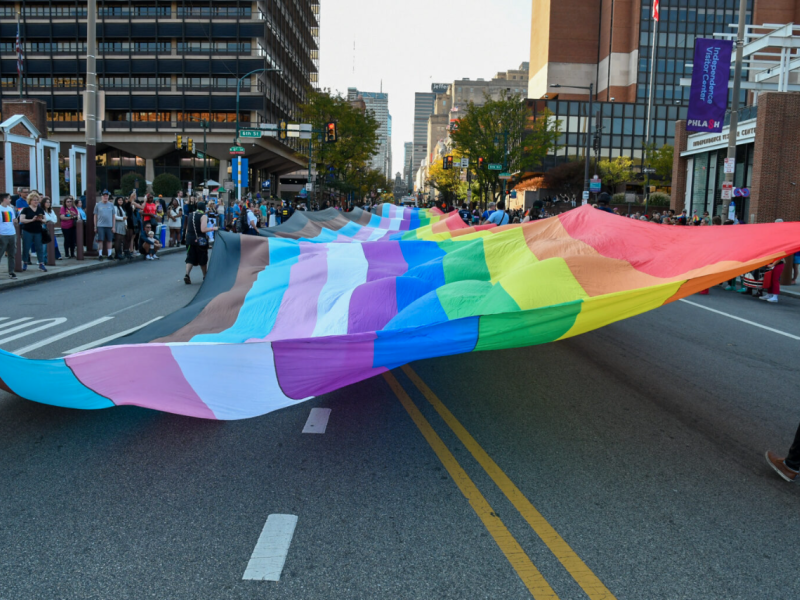 400 foot pride flag being carried by OURfest parade marchers down a Philadelphia street