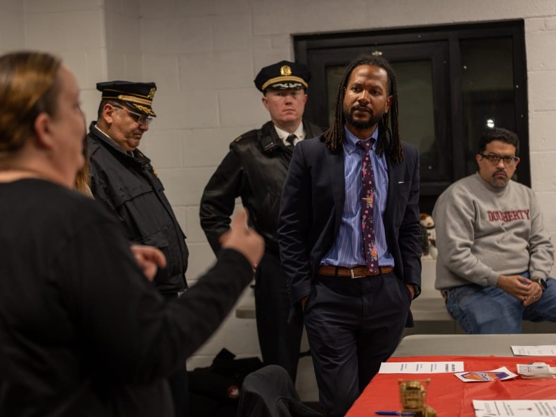 Woman addressing Chief Public Safety Director at a community meeting