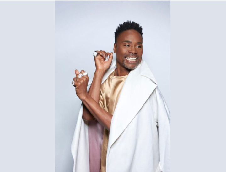 Photo of Billy Porter smiling in a white coat