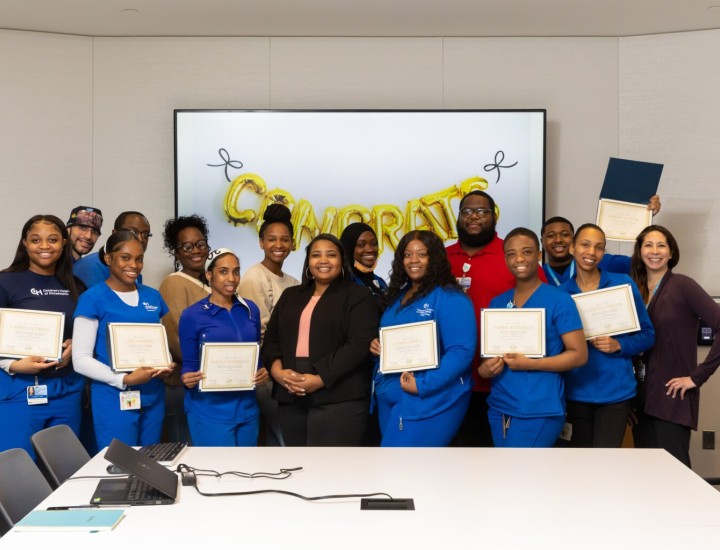 Health care workers holding certificates and celebrating the completion of a skills training